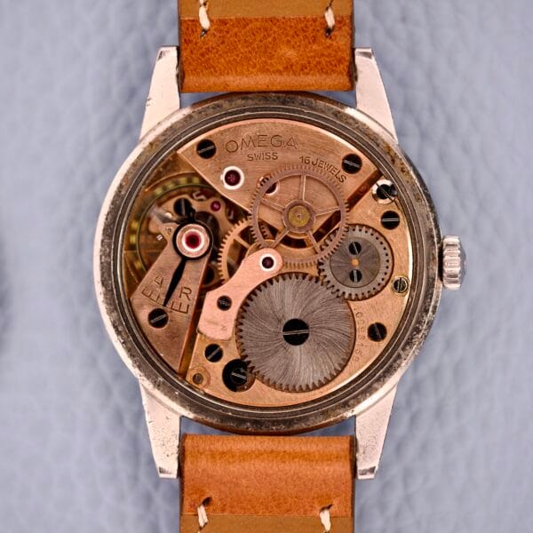 Close-up of the exposed 30T2 mechanical movement inside an Omega Ref. 2271-2 Jumbo Stainless Steel Case wristwatch with a brown leather strap.