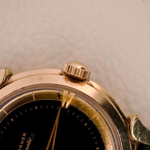 Close-up of a Wittnauer Automatic Black Gilt Dial Cal. 11ARG wristwatch, with visible tarnish and wear near the crown.