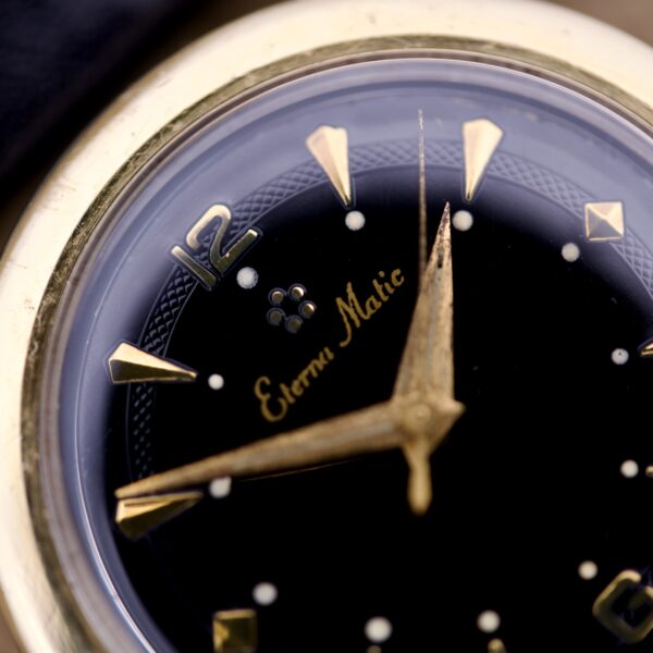 Close-up of the Eterna Matic Black Dial 14k Gold Capped Case wristwatch, showcasing its elegant 14k gold details and bold black dial.