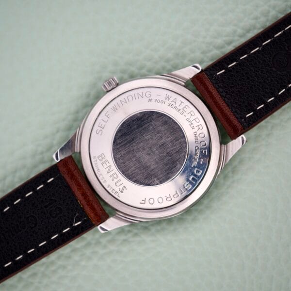 Back of a Benrus 3 Star Automatic #7001 Series Stainless Steel watch with leather strap, featuring engraved text on the brushed steel center.
