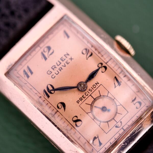 Close-up of the Gruen Curvex Precision Ref. 440-448 Rose Gold Filled wristwatch featuring a rectangular face and black leather strap.