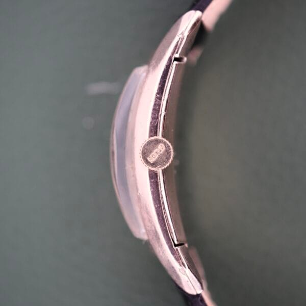 Side view of the Gruen Curvex Precision Ref. 440-448 in rose gold filled, black strap visible, showcasing the signature curved design and precise craftsmanship.