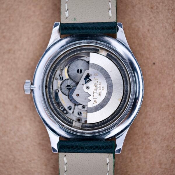 Back view of the Wittnauer Pert-O-Graph Ref. 7005, featuring exposed gears, intricate mechanical movement, and the rare Pert-O-Graph Scale Bezel.