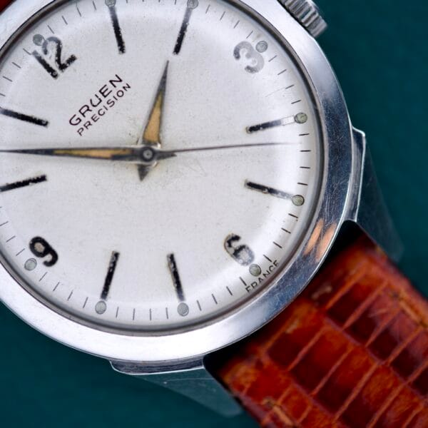Close-up of the Gruen Precision White Dial from France, featuring a Cal. 515SS movement and a brown leather strap.