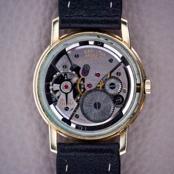Close-up of the Hamilton Sea-Scape Sunburst Dial Manual Wind Cal. 671 wristwatch, highlighting its exposed gears, mechanical movement, and eye-catching sunburst dial.