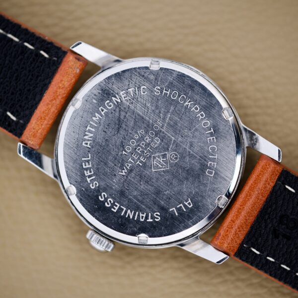 Back of a Helbros Invincible 21 Jewels Manual Wind Stainless Steel Case wristwatch, highlighting its waterproof, antimagnetic, and shock protection features.