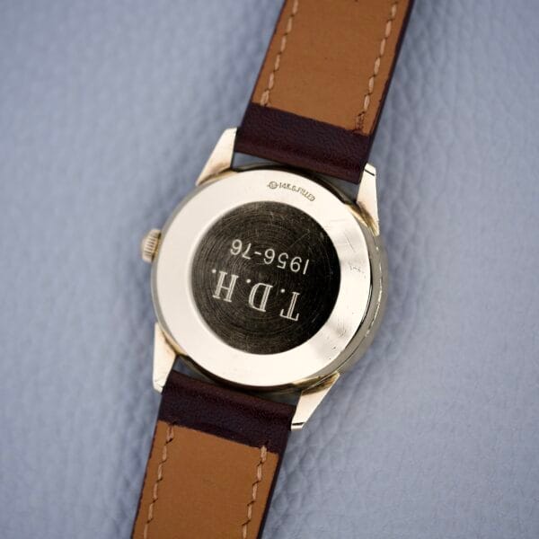 Rolex Presentation Watch Ref. 7002, 14k gold filled with brown leather strap, features a Cal. 1520 movement and engraved back reading “TDH 1956-76.”.