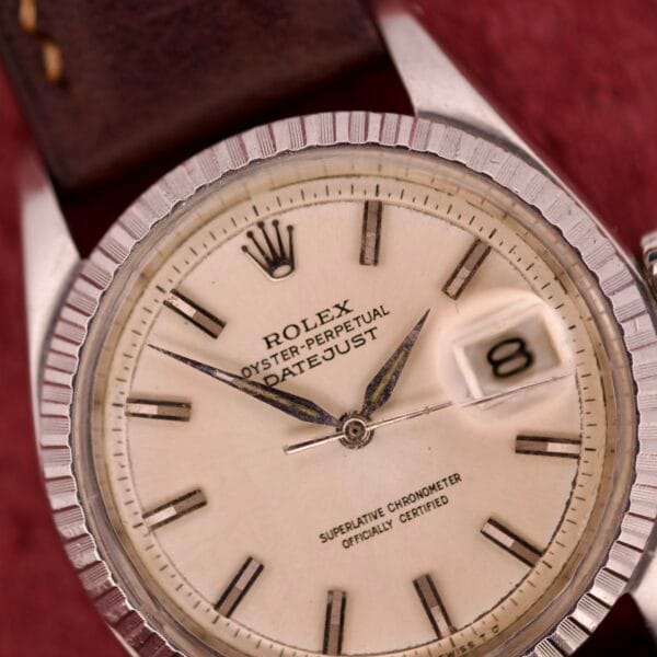 Close-up of a Rolex Datejust 1603 Silver Dial Alpha hands watch, focusing on the time and the magnified date window showing 8.