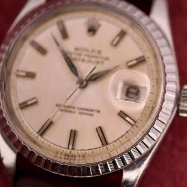 Close-up of a vintage Rolex Datejust 1603 with a silver dial and Alpha hands.
