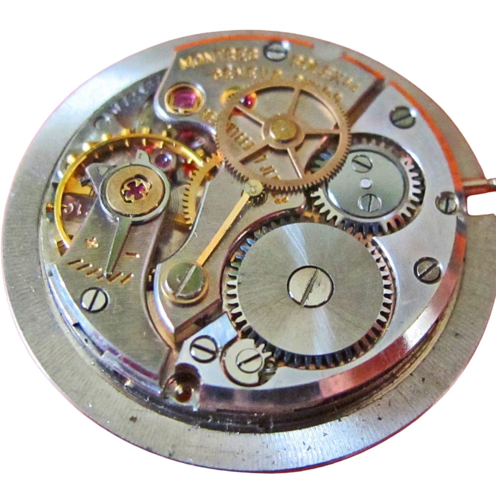 Close-up of mechanical watch movement showing interlocking gears and metal components.