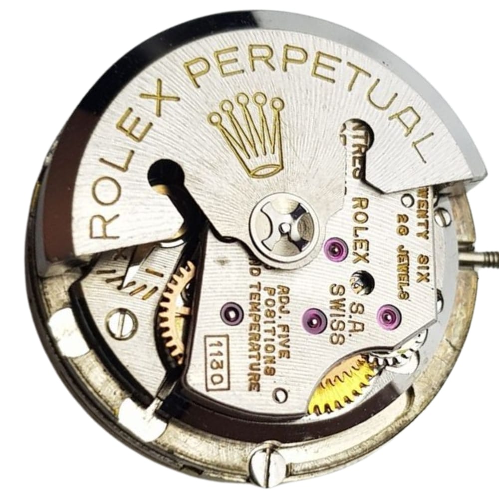 Close-up of a Rolex Perpetual watch movement, showing gears, text, and the Rolex crown logo.