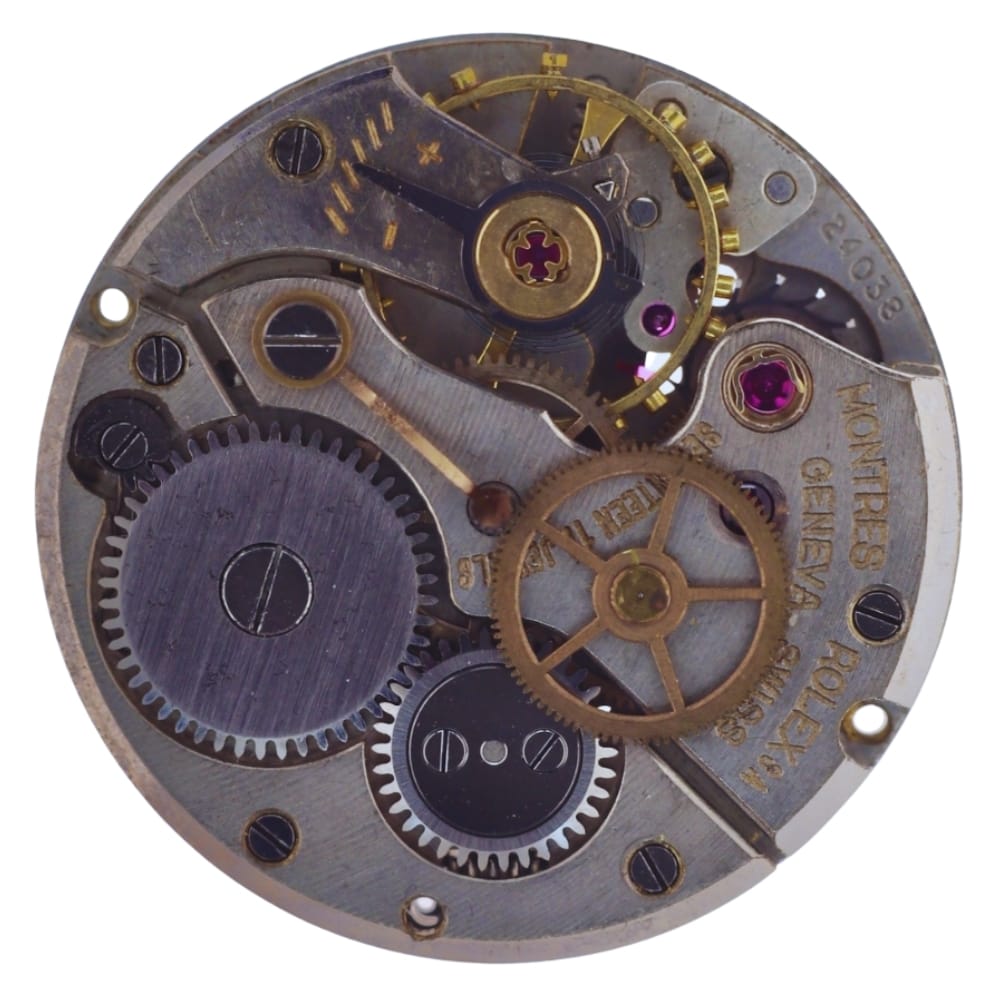 Close-up of a mechanical watch movement showing gears, wheels, and engraved text on the metal surface.