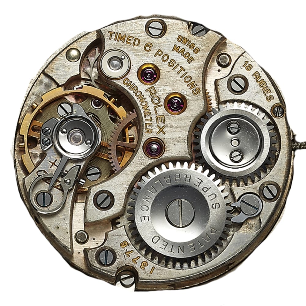 Close-up of a Rolex watch movement showing gears, screws, and engraved text on the metal components.