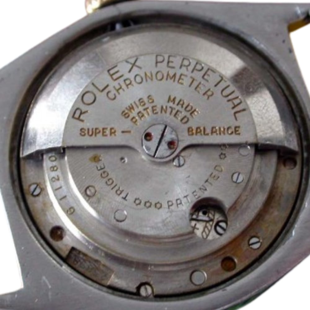 Close-up of a Rolex Perpetual Chronometer watch movement showing engraved text and mechanical parts.