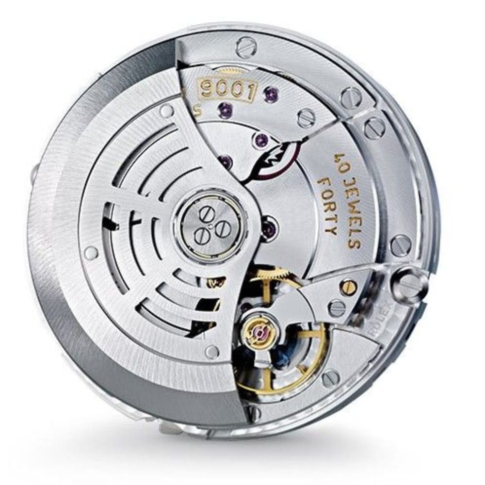 Silver mechanical watch movement with visible gears, rotor, and 40 JEWELS FORTY engraved on the plate.