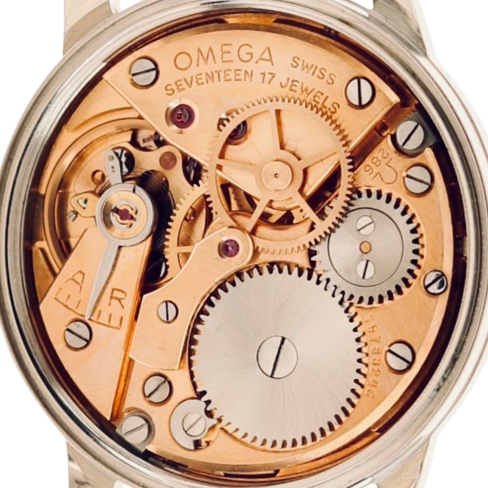 Close-up of an Omega Swiss watch movement showing intricate gears and SEVENTEEN 17 JEWELS engraving.
