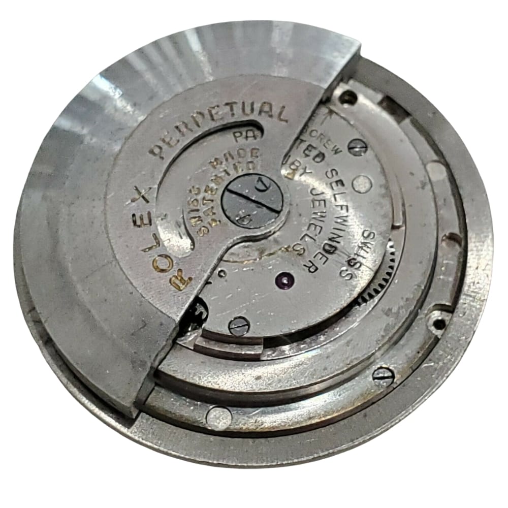 Rolex watch movement mechanism with engraved text and visible gears on a white background.