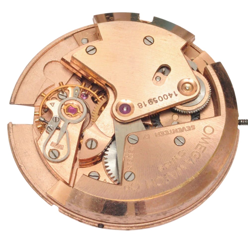 Close-up of a vintage Omega watch movement, showing intricate gears and mechanical components in gold tones.