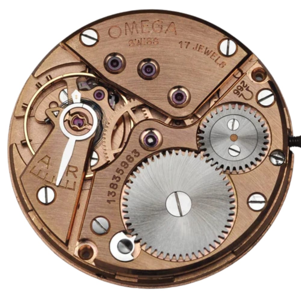 Close-up of a copper Omega watch movement showing gears, screws, and intricate mechanical details.