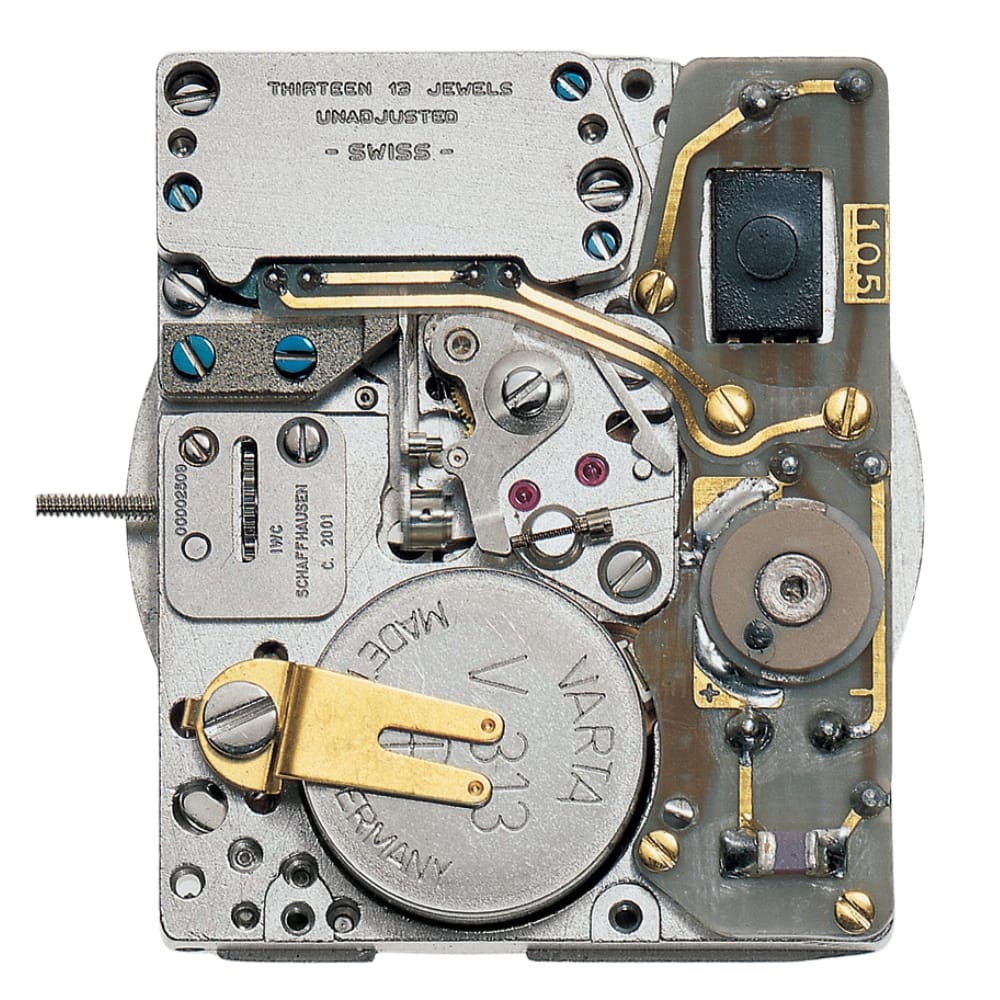 Close-up of a watch movement with visible gears, battery, screws, and electronic components.