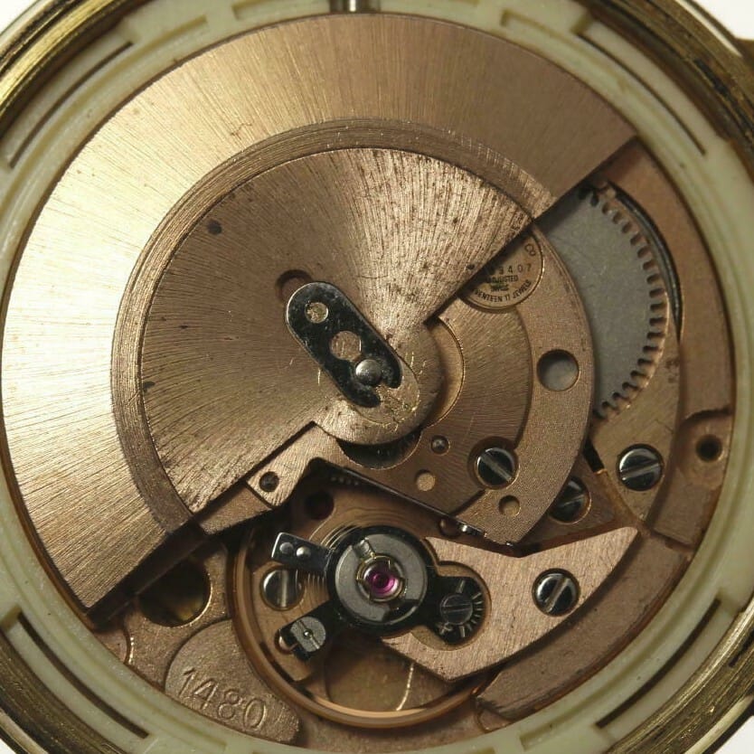 Close-up of the intricate inner gears and mechanisms of a vintage wristwatch.