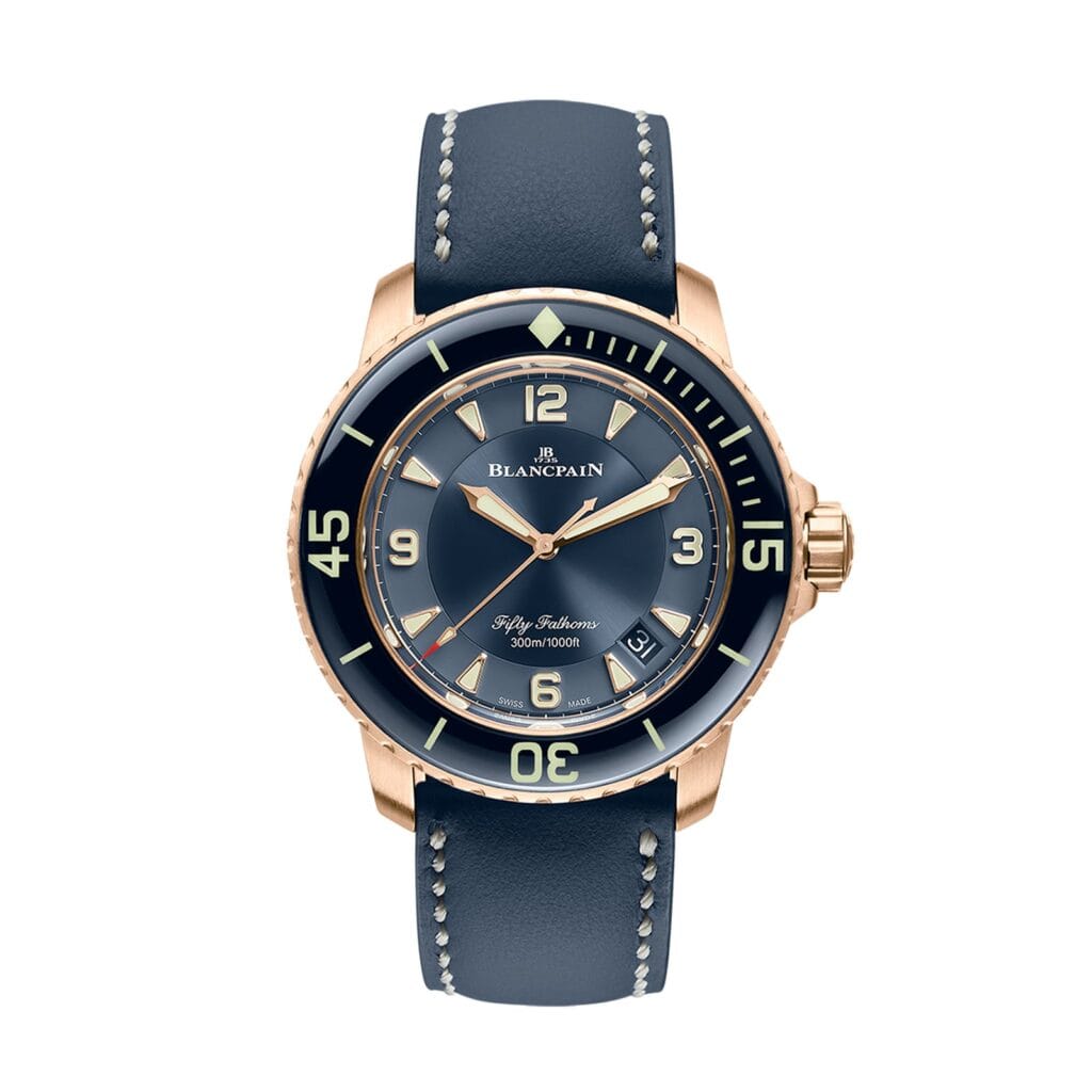 A luxury Blancpain Fifty Fathoms 5015-3603C-63B dive watch featuring a blue dial, gold case, and blue leather strap.