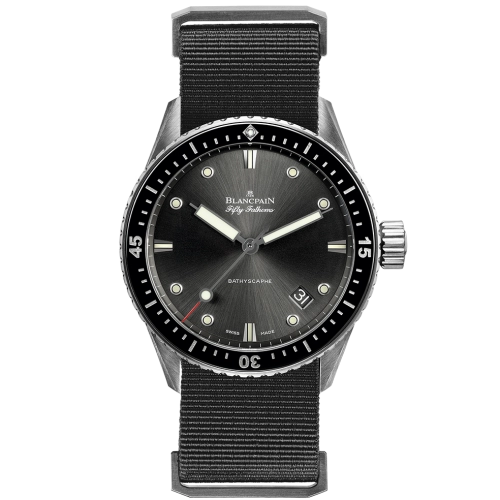 A Blancpain Fifty Fathoms dive watch, reference 5000-1110-NABA, features a black dial, black bezel, and black fabric strap, elegantly displaying the time 10:10.