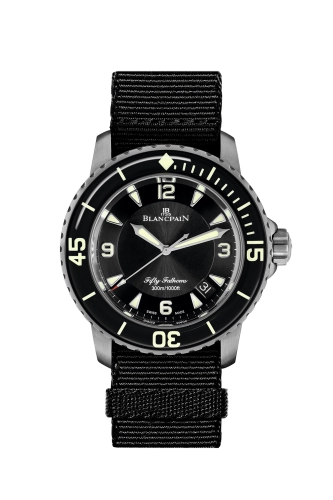 A luxury dive watch, the black Blancpain Fifty Fathoms 5015-12B30-NABA features a black fabric strap and luminous markers.