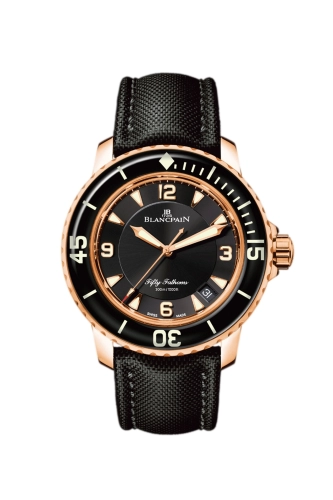A luxury watch, this Blancpain Fifty Fathoms 5015-3630-52A features a black dial, gold bezel, and a black textured leather strap.