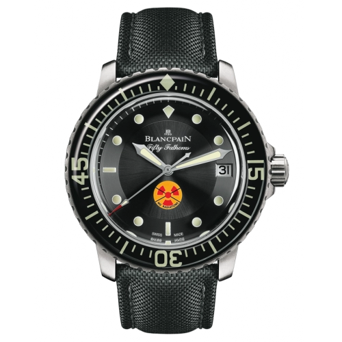 A luxury watch, the Blancpain Fifty Fathoms 5015B-1130-52 features a black dial, date display, and a striking yellow-red radiation symbol at 6 o’clock.
