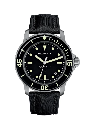 A luxury watch, the Blancpain Fifty Fathoms 5015E-1130-B52A features a black dial with luminous markers and a sleek black fabric strap.