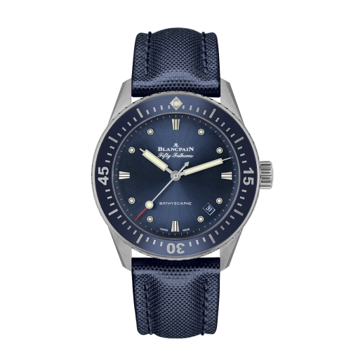 A blue Blancpain Fifty Fathoms 5100-1140-O52A luxury watch with a fabric strap and luminescent hour markers.
