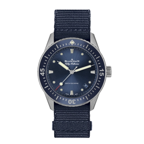 A navy blue Blancpain Fifty Fathoms 5100B-1110-NAOA luxury watch with a fabric strap and crisp white markers on the dial.