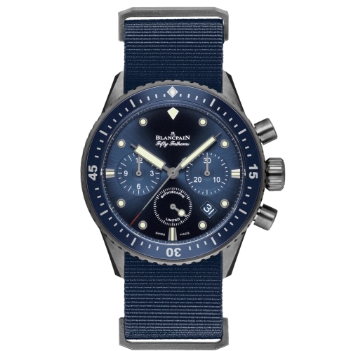A navy blue Blancpain Fifty Fathoms wristwatch, model 5200-0240-NAOA, featuring three subdials, a date window, and a durable fabric strap.