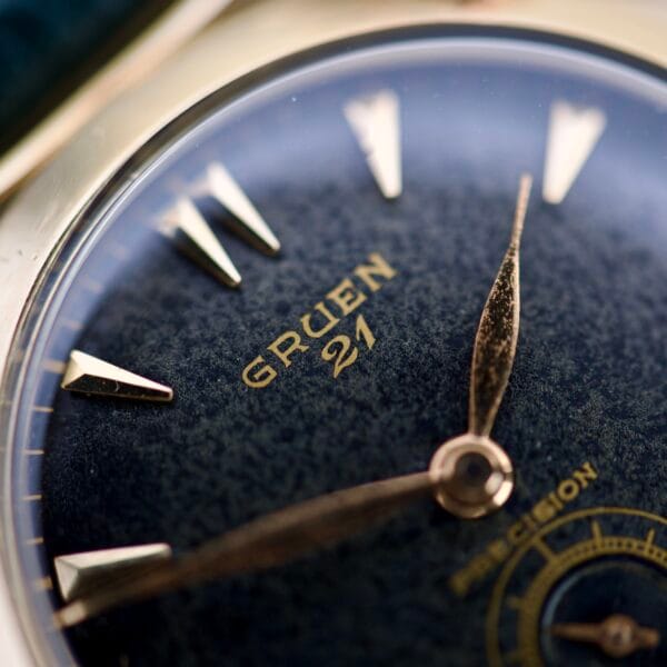 Close-up of a vintage Gruen Barclay "Spider" Ref. 335-723 21 Jewels Cal. 335 wristwatch, highlighting the dial, hands, and gold hour markers.