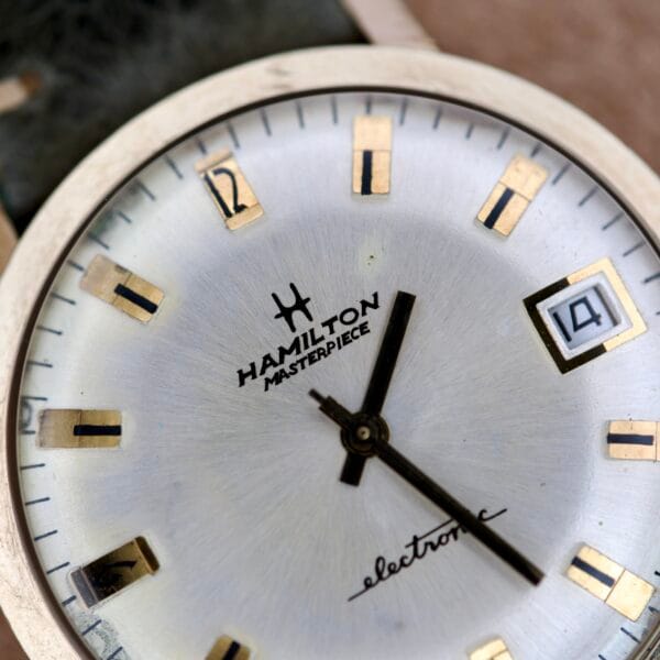 Close-up of a Hamilton Masterpiece Electronic Date Ref. 981569 watch face, showcasing the Electronic Date display and Cal. 702 marking.