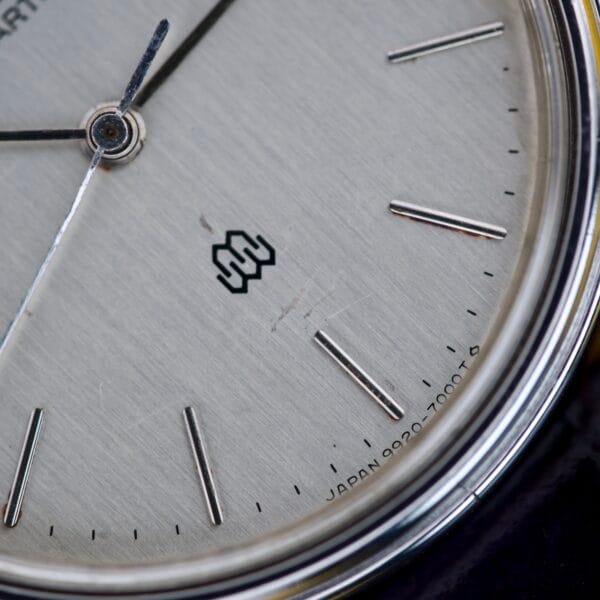 Close-up of a Seiko Twin Quartz Ref. 9920-7000T Thin Stainless Steel watch face, showcasing minimalist hour markers, sleek stainless steel accents, and "JAPAN" printed near the edge.