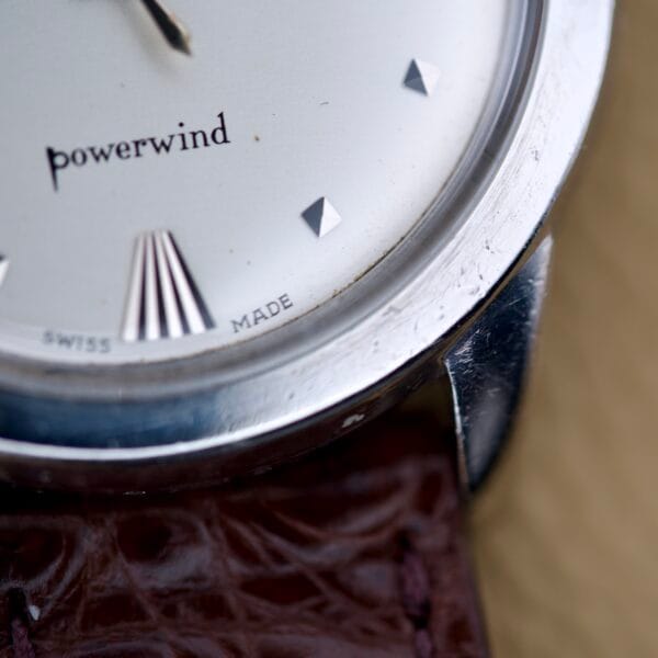 Close-up of a Mido Multifort Powerwind White Dial Automatic Cal. 917P wristwatch with a brown leather strap.