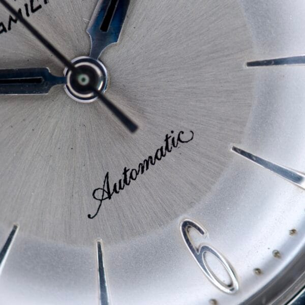 Close-up of a Hamilton Accumatic X Sunburst Dial Stainless Steel Cal. 667 watch face, showing "Automatic" and the number six.