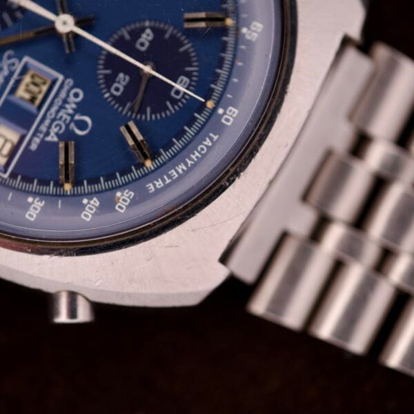 Close-up of a blue Omega Seamaster Speedsonic F300 Ref. 188.0002 chronograph with original bracelet, Spanish date display, and distinctive tachymeter scale on the wristwatch face.