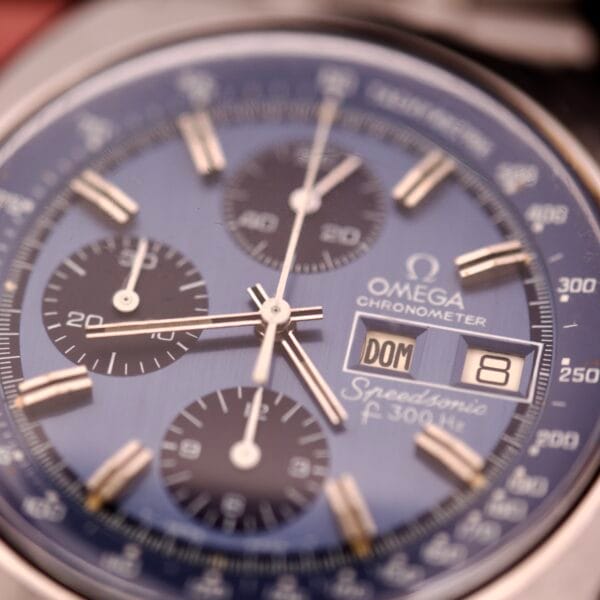Close-up of an Omega Seamaster Speedsonic F300 Ref. 188.0002 chronograph on original bracelet, featuring a blue dial and Spanish date display set to 8.
