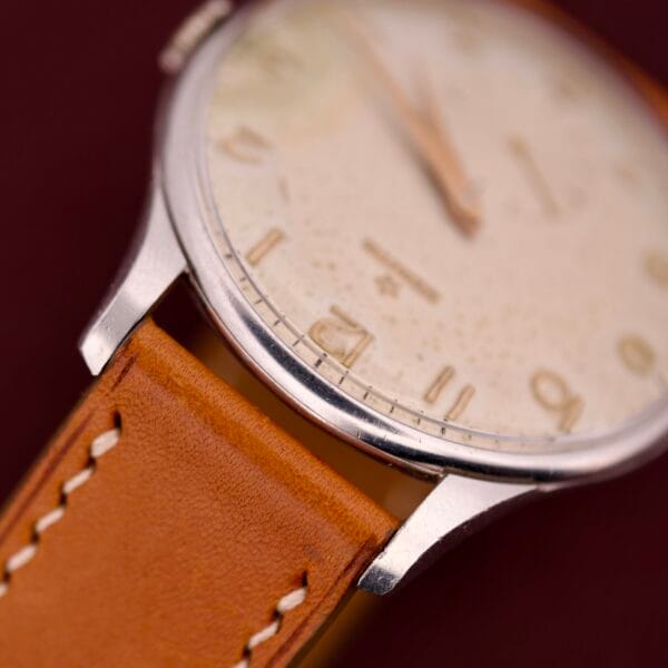 Close-up of the Zenith Caltrava Jumbo, featuring a stainless steel case, tan leather strap, and cream-colored dial with Arabic numerals and subseconds.