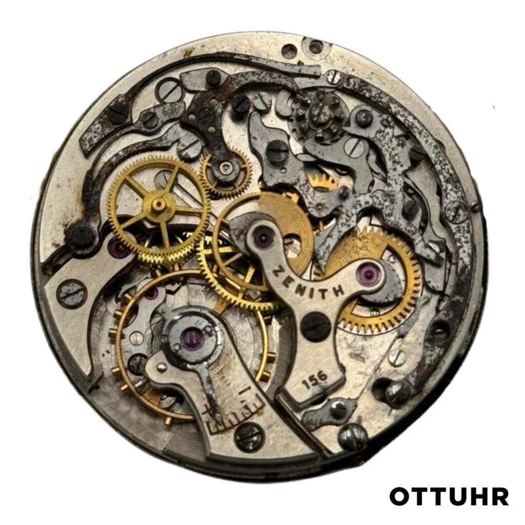 Close-up of a vintage Zenith 156 watch movement with visible gears and intricate mechanical parts.