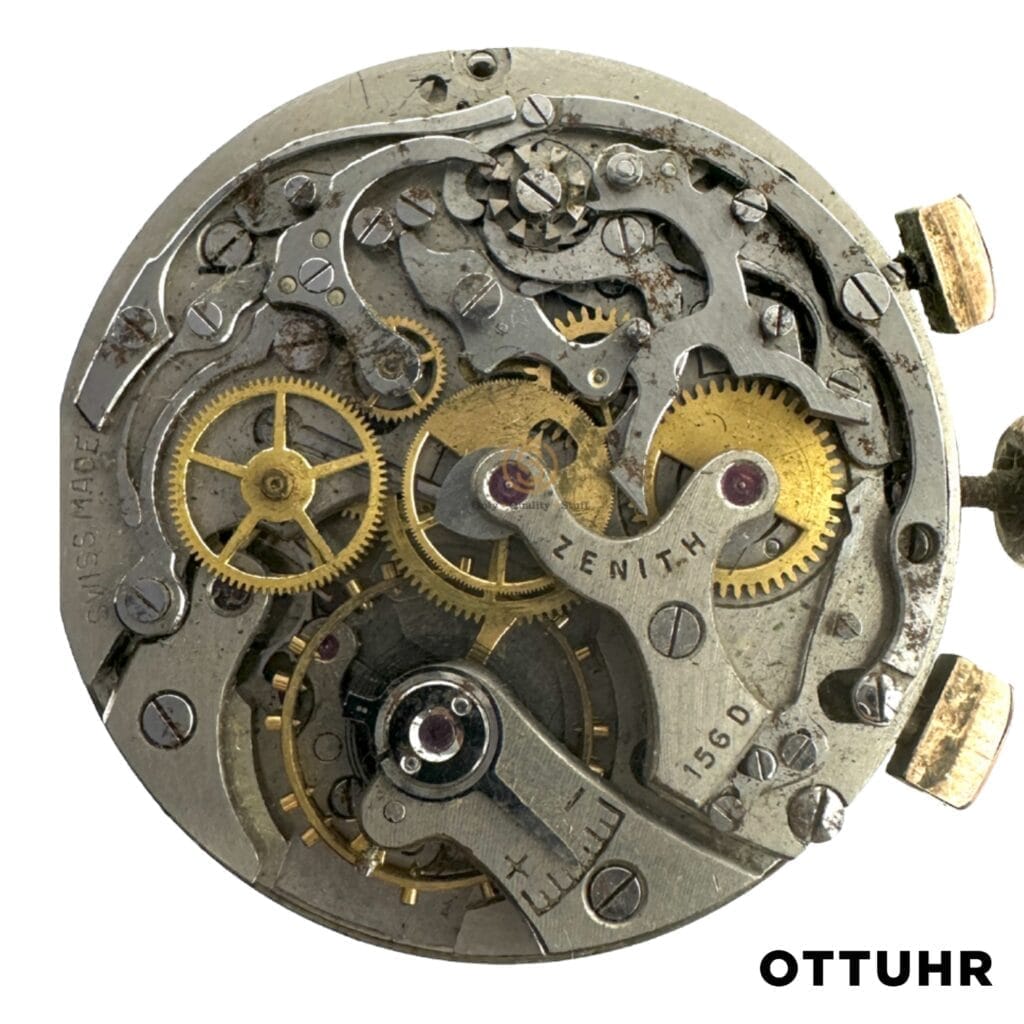 Close-up of a vintage Zenith mechanical watch movement, featuring the intricate 156d caliber with visible gears and "Zenith" engraved on a metal component.