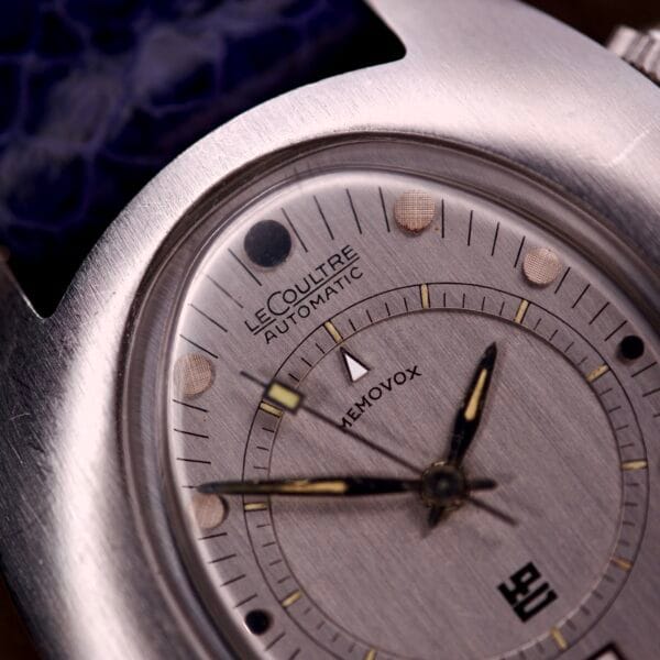 Close-up of a vintage Lecoultre Automatic Memovox Reveil "Egg" Ref. 3072-916 with Cal. 916 movement, silver dial, and textured blue strap.