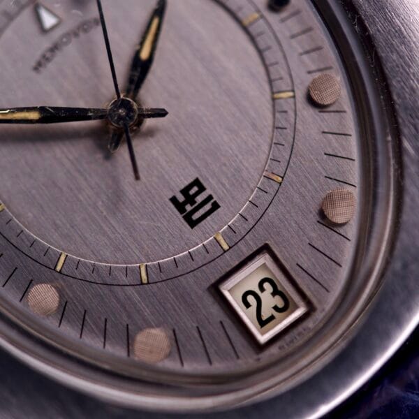 Close-up of a Lecoultre Automatic Memovox Reveil "Egg" Ref. 3072-916 Cal. 916 watch face, featuring bold black markings, textured hour markers, and the date set to 23—capturing its timeless design.