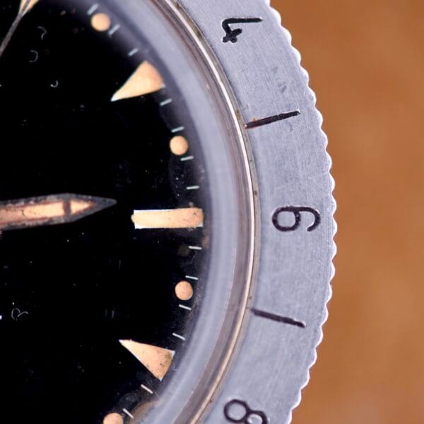 Close-up of a Bulova Accutron Astronaut 214 GMT 24 Hour Bezel Black Dial watch face, displaying the numbers 4, 9, and 8.
