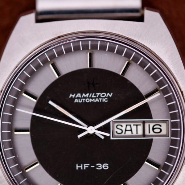 Close-up of a Hamilton Automatic HF-36 Day-Date Hi-Beat Cal. 631 wristwatch displaying its Day-Date feature, with SAT and 16 clearly visible on the dial.