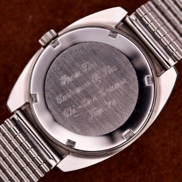 Close-up of a Hamilton Automatic HF-36 Day-Date Hi-Beat Cal. 631 watch back, engraved with a message to Customers of the Chi-Chi Lounge, Jan 1978.