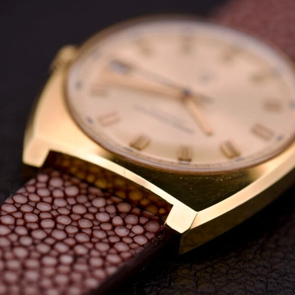 Close-up of a Girard Perregaux Electronic Ref. 9280 6H with a Large Cushion Case and brown textured leather strap, displayed on a dark surface.